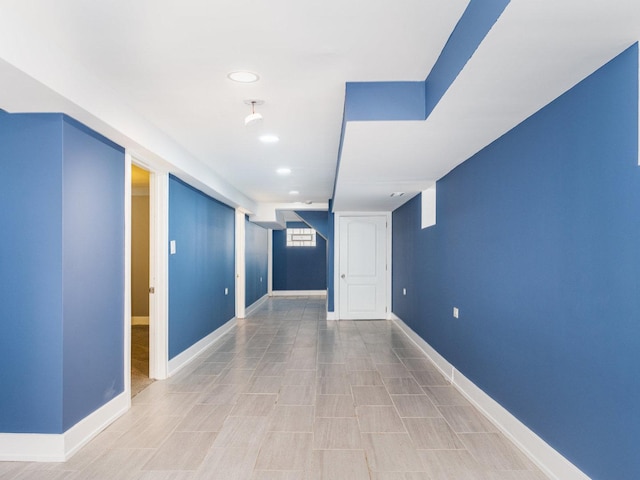 unfurnished room with recessed lighting and baseboards