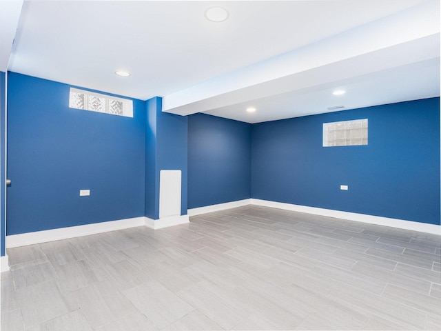 below grade area featuring recessed lighting, baseboards, and wood finished floors