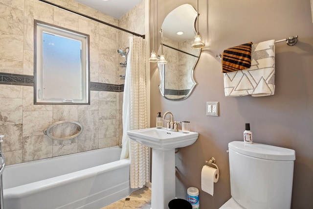 bathroom featuring a sink, toilet, and shower / bath combo with shower curtain