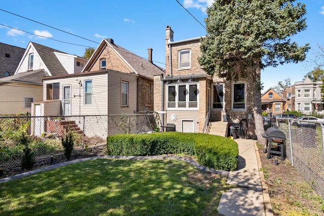 exterior space featuring fence, a lawn, and brick siding