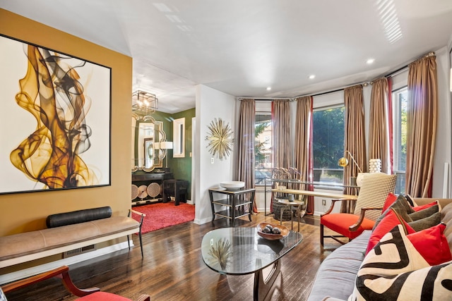 living area featuring recessed lighting, plenty of natural light, an inviting chandelier, and wood finished floors