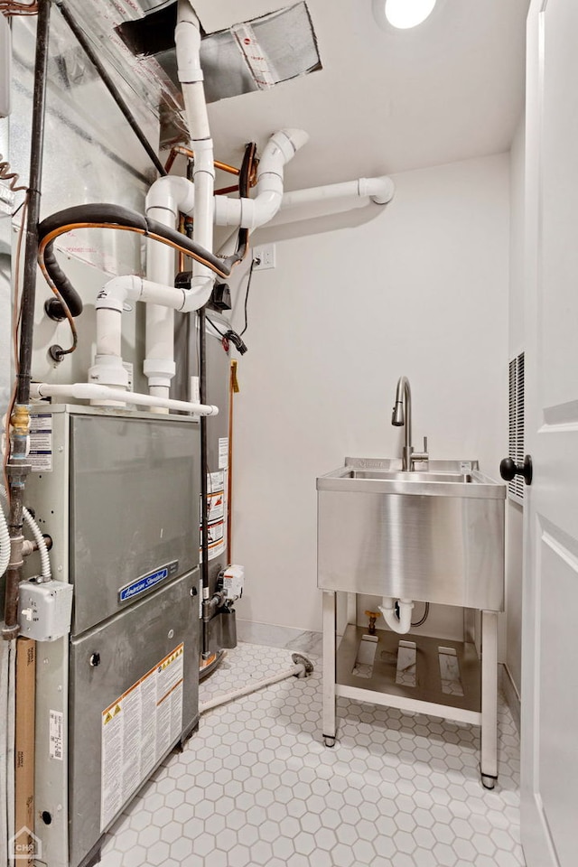 utility room with a sink and heating unit