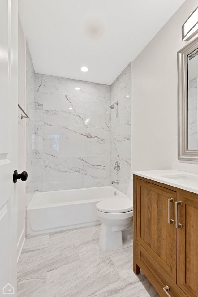 full bathroom featuring toilet, marble finish floor,  shower combination, and vanity