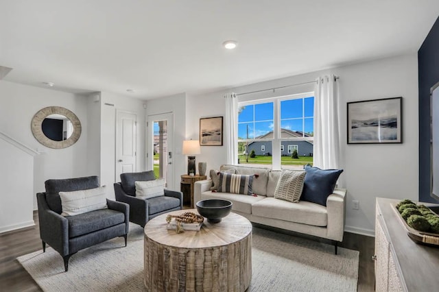 living room featuring dark wood finished floors and baseboards