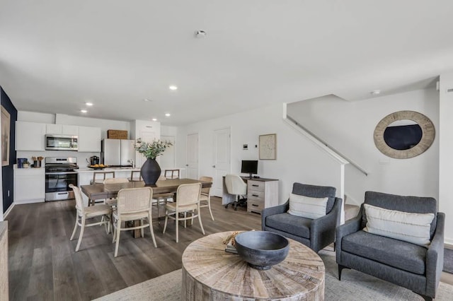 dining room featuring dark wood-style floors, stairway, and recessed lighting