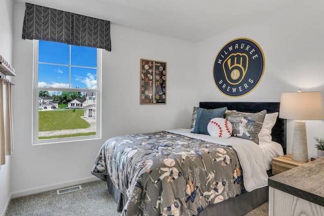 bedroom with baseboards, visible vents, and carpet flooring