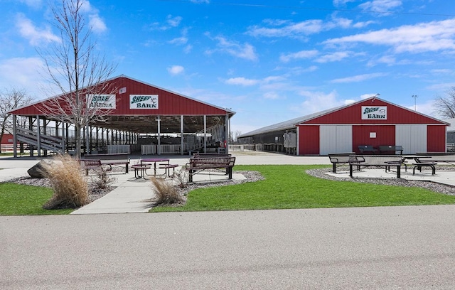 view of community featuring a pole building and an outdoor structure