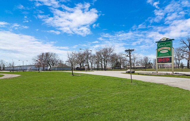 surrounding community featuring a yard and driveway