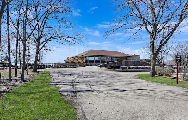 view of property's community featuring aphalt driveway