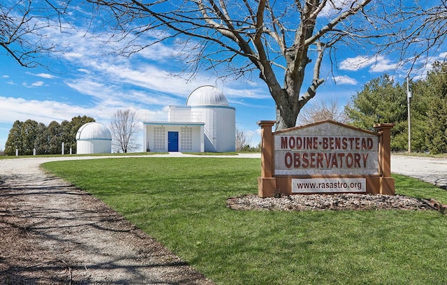community / neighborhood sign featuring a lawn