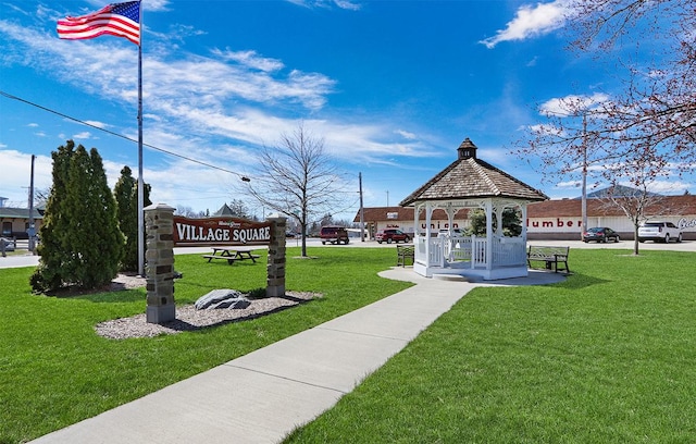 view of property's community featuring a lawn and a gazebo