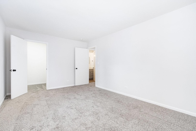 unfurnished bedroom featuring carpet floors and baseboards