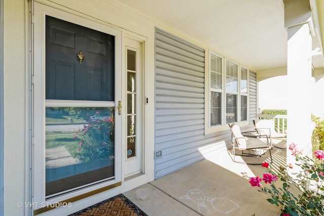 view of exterior entry with a porch