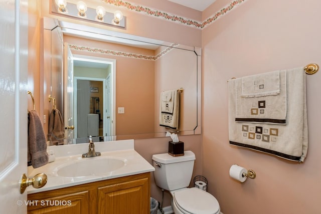 half bathroom with vanity and toilet