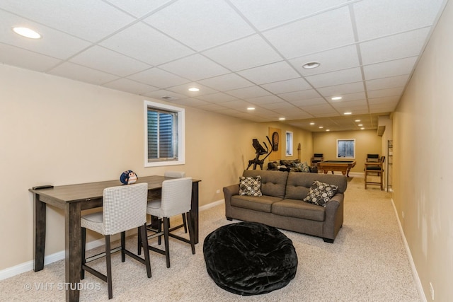 carpeted living room with a drop ceiling, recessed lighting, and baseboards