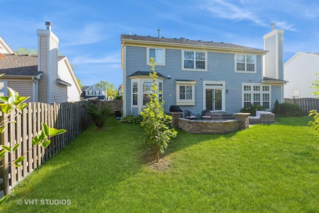 rear view of property featuring a fenced backyard, a lawn, and a patio