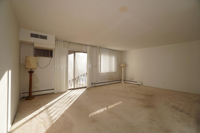 carpeted spare room featuring a wall unit AC, visible vents, and baseboard heating