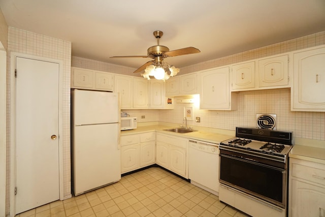 kitchen with white appliances, visible vents, light countertops, and a sink