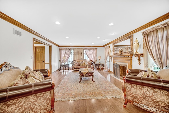 living area featuring a fireplace, wood finished floors, visible vents, and recessed lighting