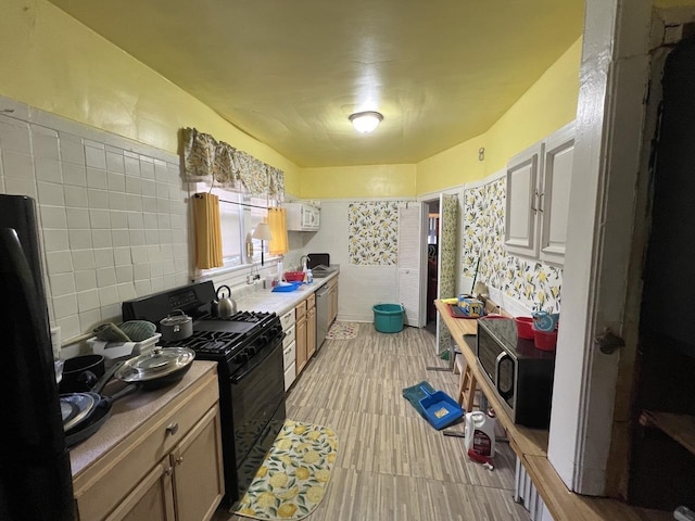 kitchen featuring black appliances and light wood finished floors