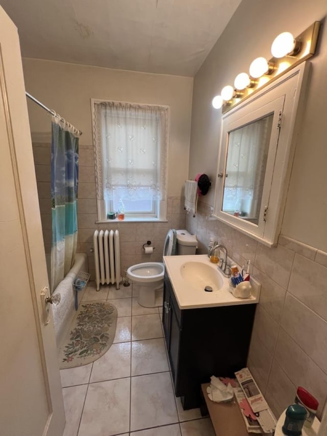 bathroom featuring tile walls, toilet, radiator heating unit, vanity, and tile patterned floors