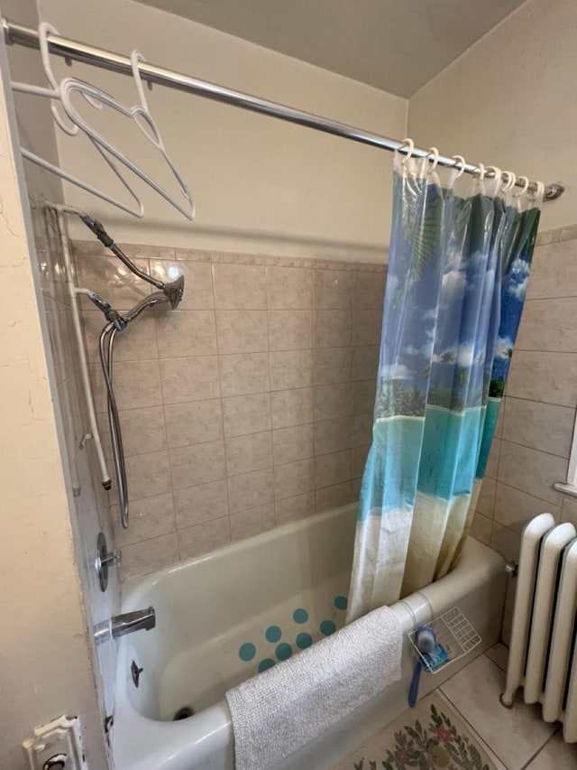 bathroom featuring radiator heating unit, shower / bath combo, and tile patterned flooring