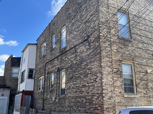 view of side of property with brick siding