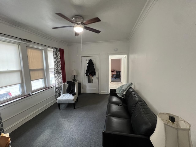 living room with a ceiling fan, baseboards, and crown molding