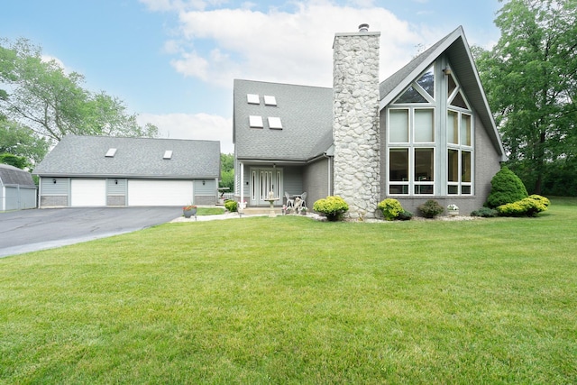 view of front facade with a garage, a shingled roof, brick siding, a chimney, and a front yard