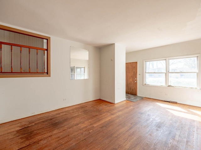 unfurnished room with wood finished floors