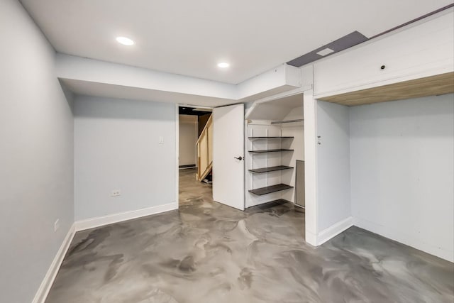 finished below grade area with recessed lighting, baseboards, and stairs