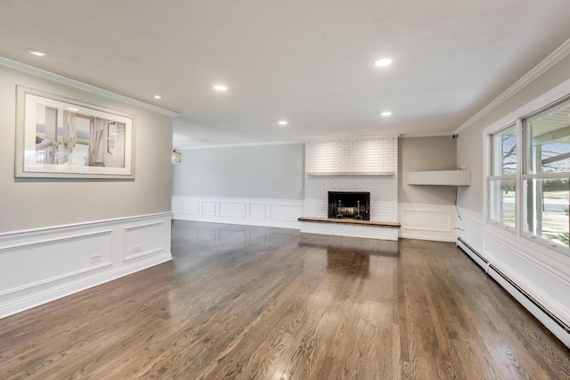 unfurnished living room featuring dark wood-style floors, a baseboard radiator, recessed lighting, a fireplace, and crown molding