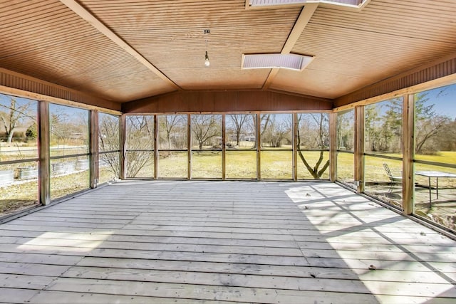 unfurnished sunroom featuring a wealth of natural light and vaulted ceiling