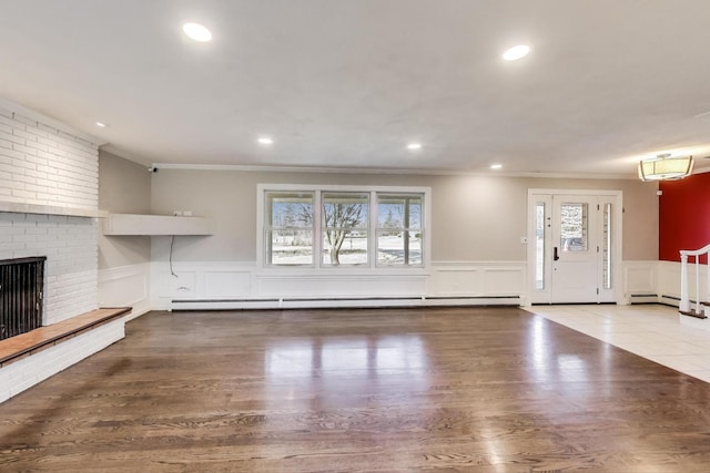 unfurnished living room featuring wood finished floors, recessed lighting, and a fireplace