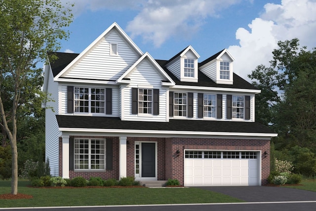 view of front facade with a garage, brick siding, a front lawn, and aphalt driveway