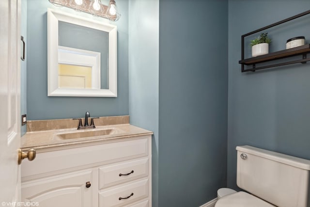 bathroom featuring toilet and vanity
