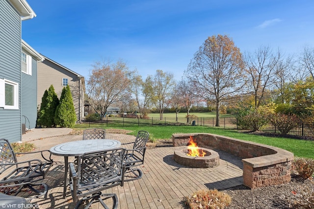 exterior space featuring a fire pit, a yard, a fenced backyard, and outdoor dining area