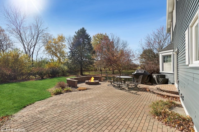 view of patio / terrace with a fire pit and fence private yard