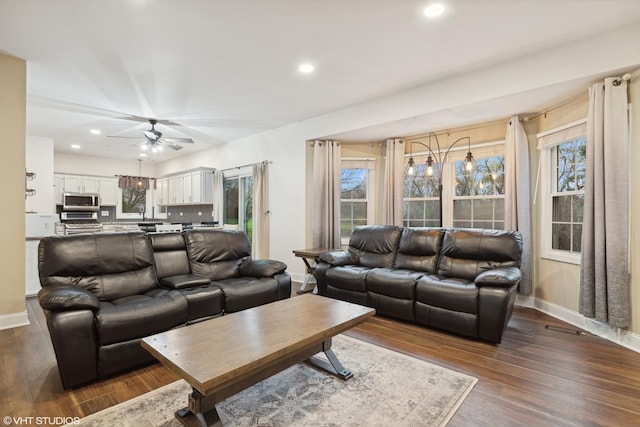 living room featuring a ceiling fan, baseboards, recessed lighting, and dark wood-style flooring