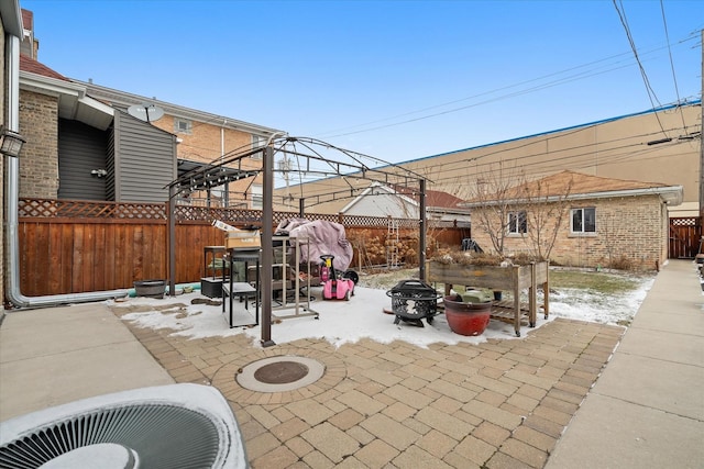 view of patio featuring an outbuilding, an outdoor fire pit, and a fenced backyard