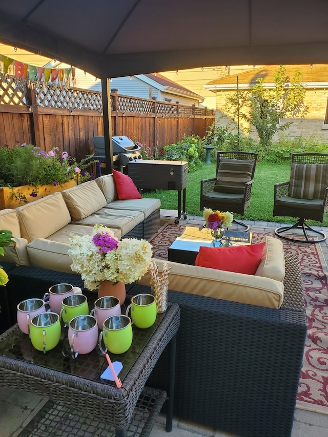 view of patio with grilling area, fence, and an outdoor living space