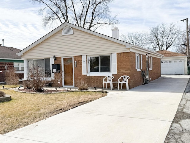 bungalow featuring a front yard, brick siding, an outdoor structure, and a chimney