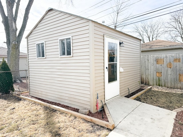 view of outbuilding with a fenced backyard and an outbuilding