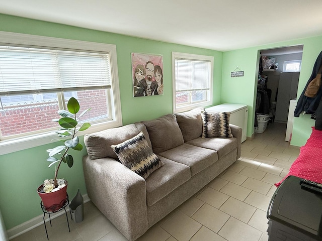 living room with light tile patterned floors and baseboards