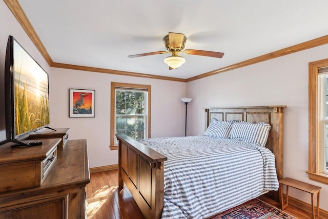 bedroom featuring baseboards, light wood-style floors, ornamental molding, and a ceiling fan