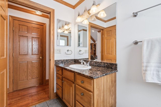 bathroom with ornamental molding, vanity, and tile patterned flooring