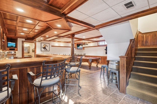 bar featuring visible vents, indoor wet bar, pool table, stairs, and wooden ceiling