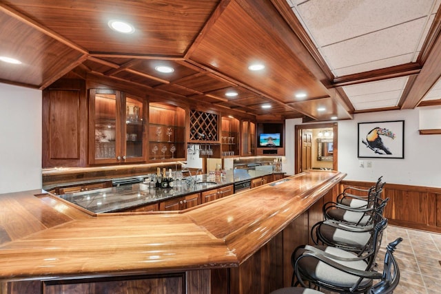 bar with a wainscoted wall, recessed lighting, wooden ceiling, and wet bar