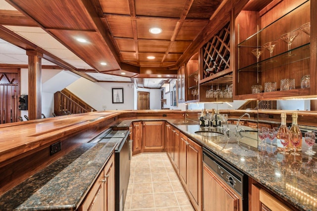 bar featuring a sink, paneled dishwasher, light tile patterned flooring, indoor wet bar, and wood ceiling