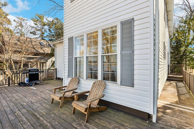 wooden terrace featuring a grill